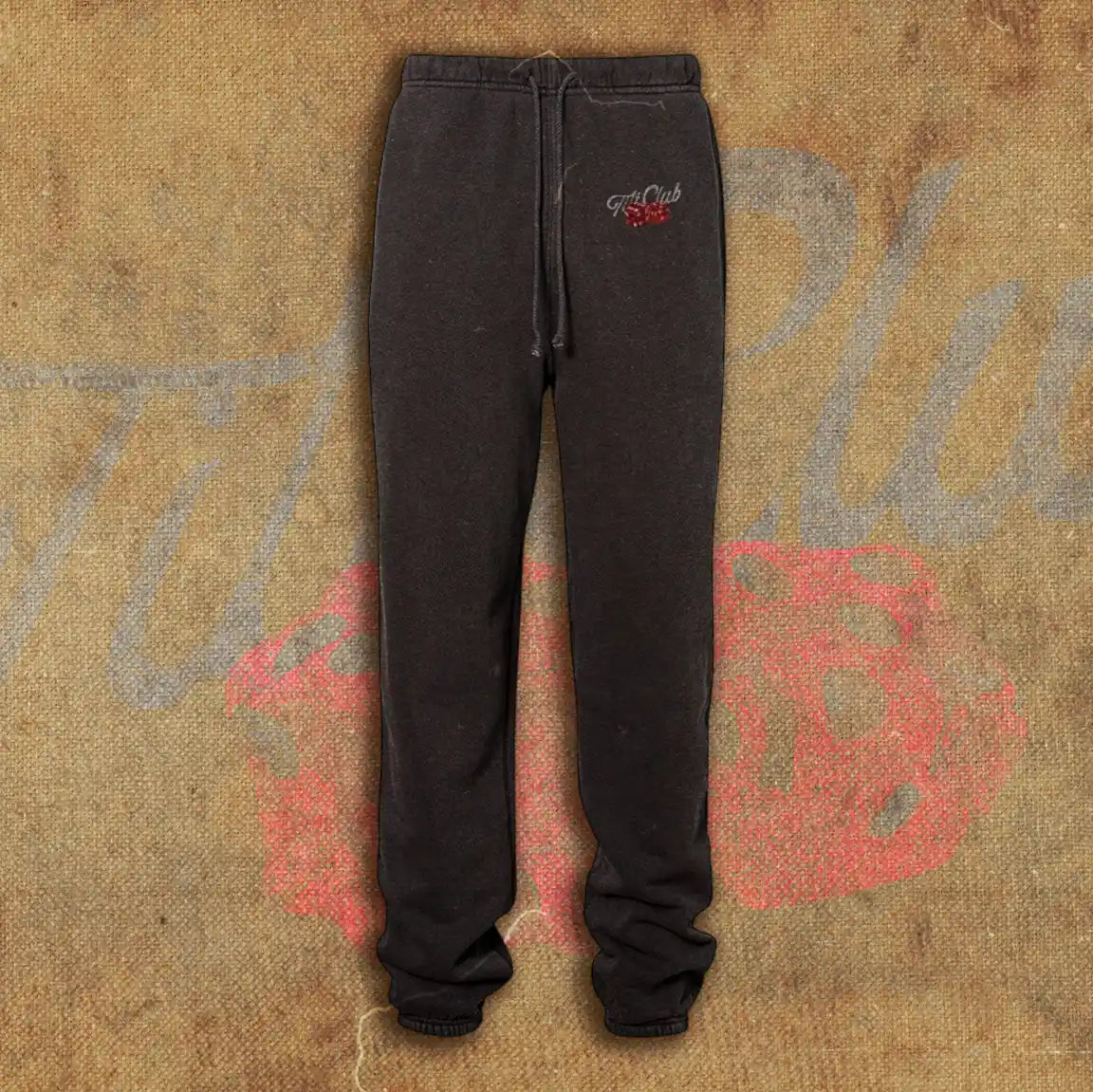 Black sweatpants featuring a minimalist design with the 'Tilt Club' logo embroidered near the waistband, complete with a drawstring closure and relaxed fit.