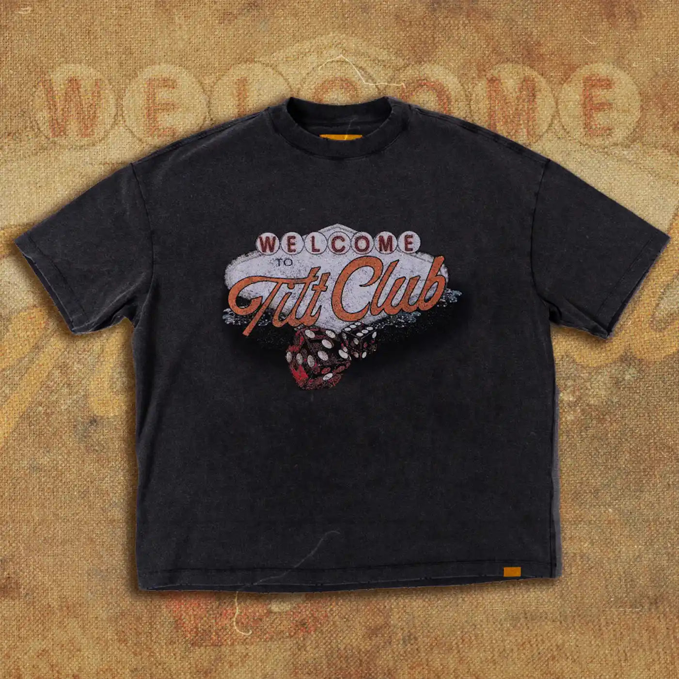 Black t-shirt featuring a vintage-inspired design with the words 'Welcome to Tilt Club' in a retro marquee style, highlighted by dice graphics and a faded, textured look.