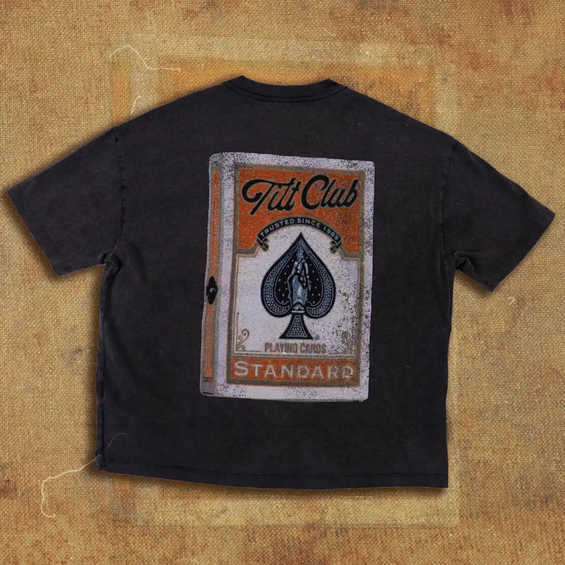 Black t-shirt featuring a large graphic of a vintage playing card design with 'Tilt Club' branding and an ornate spade symbol on the front.
