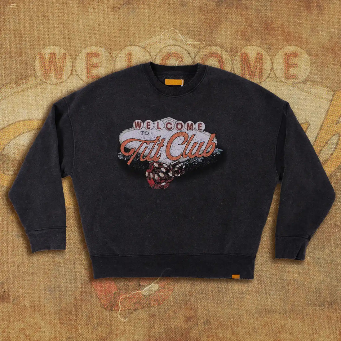 Vintage-style black sweatshirt featuring a 'Welcome to Tilt Club' Las Vegas-inspired graphic with dice illustration on the front. Retro and bold design for casual wear.
